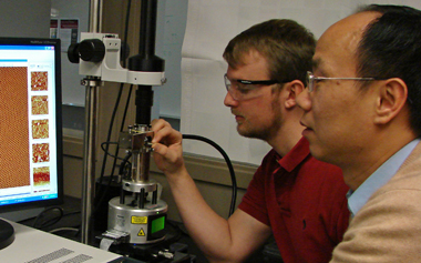 Chuanbing Tang (right) and Christopher Hardy used atomic force microscopy to characterize the nanoscale patterns they built from the bottom up.